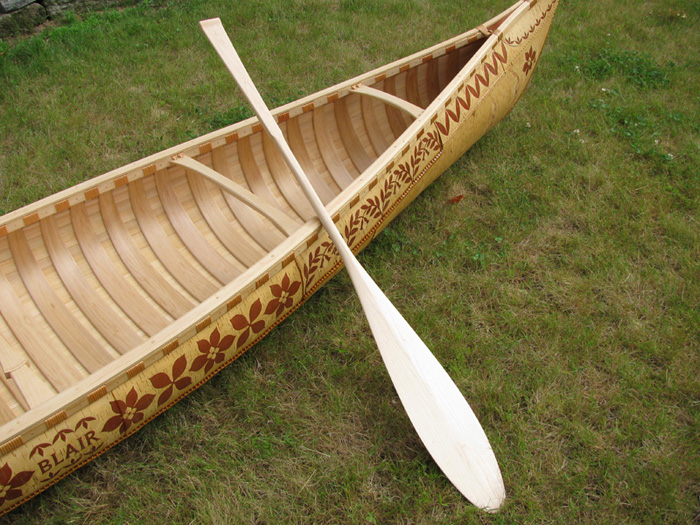 Canoe with paddle