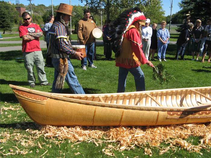 Wayne Brooks (in birchbark hat) leading the blessing of the new canoe